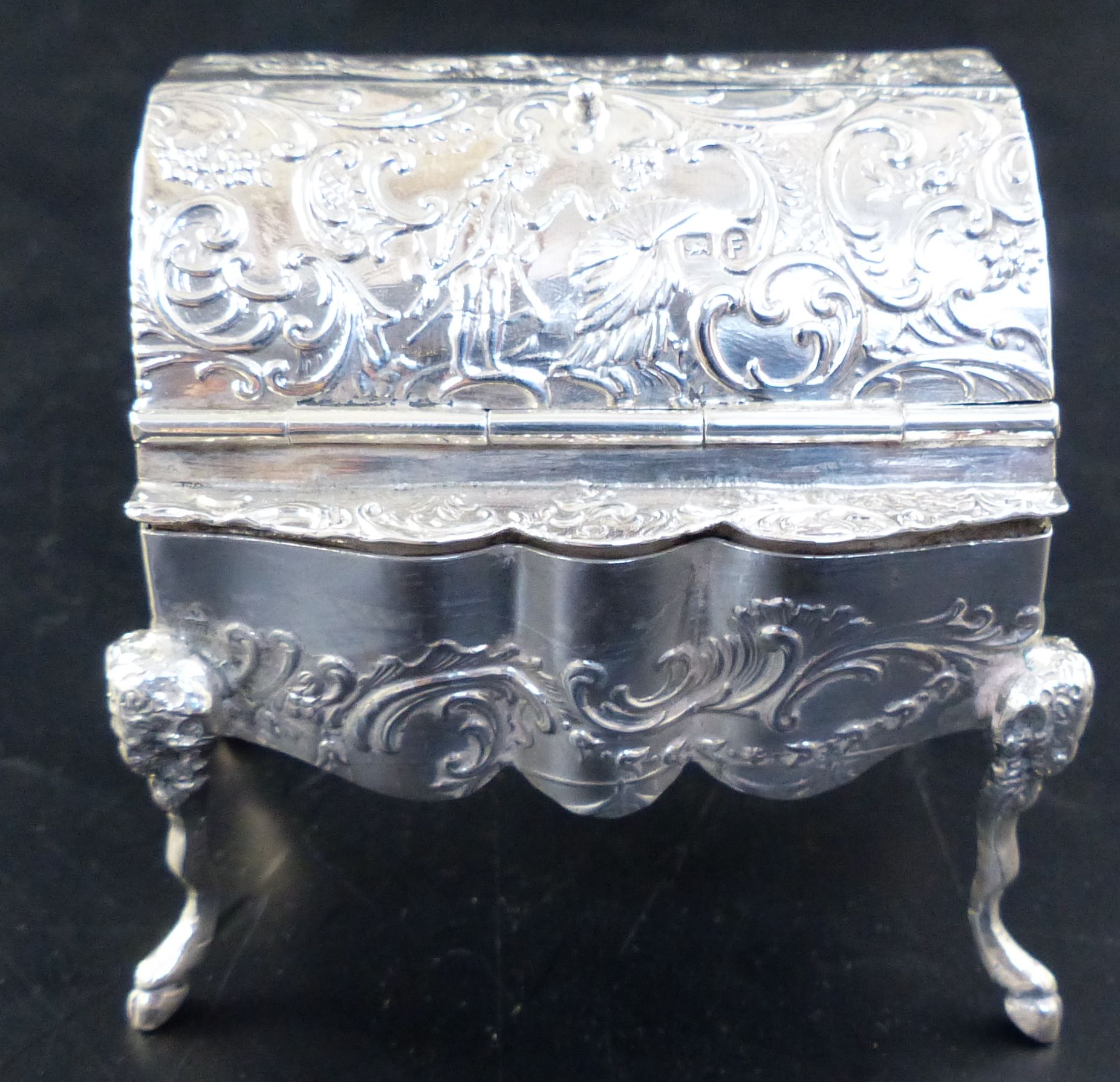 A Hanau embossed silver trinket box, formed as a miniature bureau on mask and hoof feet, width 2.5in,